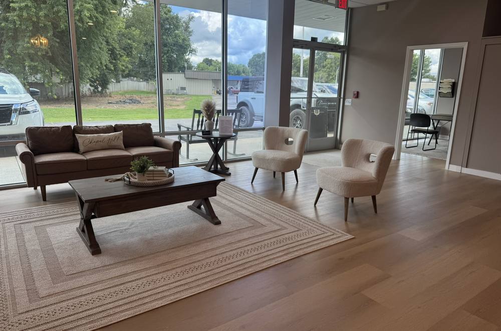 Bright lobby with leather sofa and Chapel Hill pillow
